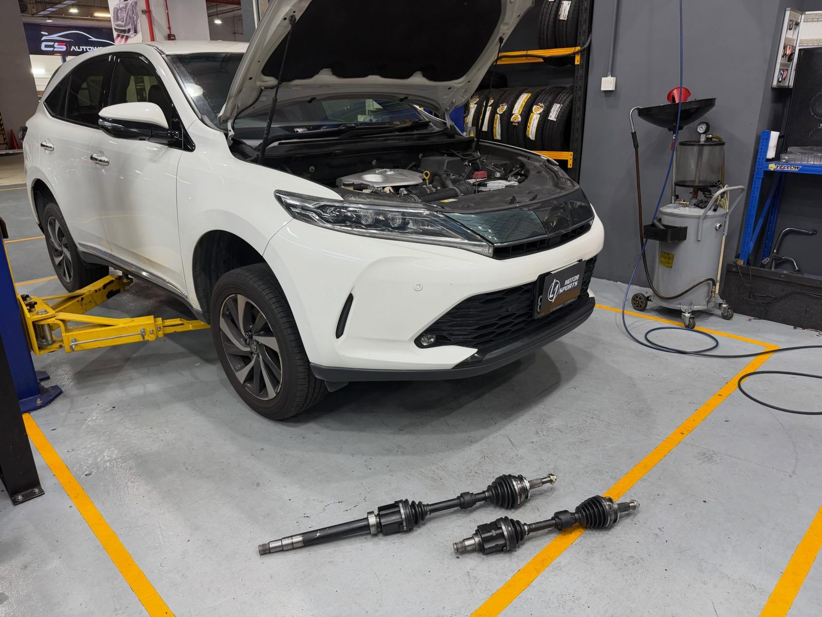 A vehicle being serviced in the L1 Motorsports workshop bay